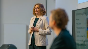 Referierende steht auf der Bühne 